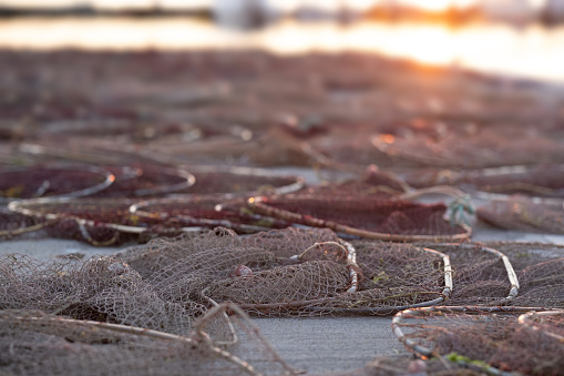 fishing nets drying on the pier at sunset