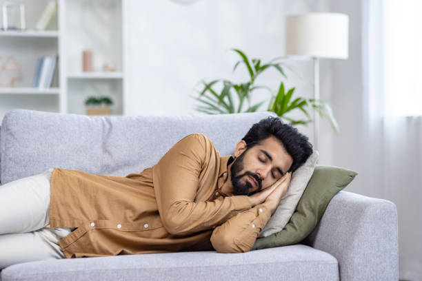 istock Young Muslim man is sleeping and resting on sofa at home 2032820533