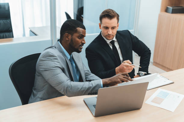 istock African male leader explain strategy while show solution to manager. Ornamented. 2032833499