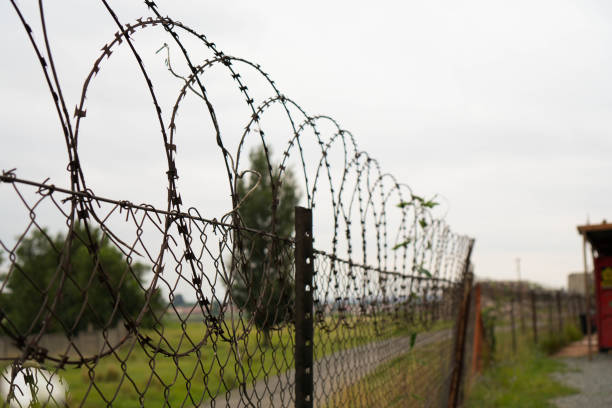istock Barbed Wire Fence With Security Measures 2032842360