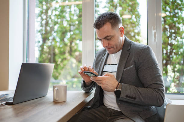 istock Businessman using his phone at the office 2032860380