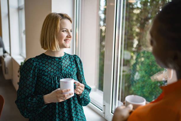 istock Two female colleagues having a coffee break at the office 2032862508