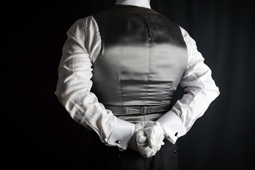 Butler in Waistcoat and White Gloves At Your Service