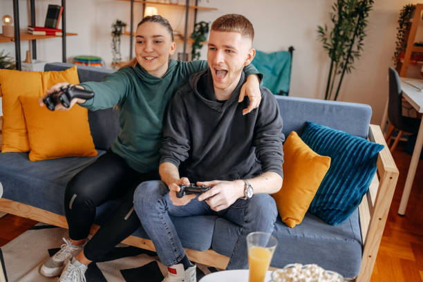 istock Couple having fun with playing video games at home 2032867361