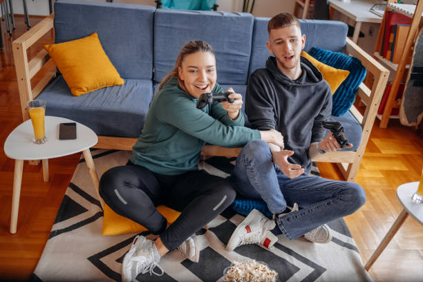 istock Couple having fun with playing video games at home 2032869495