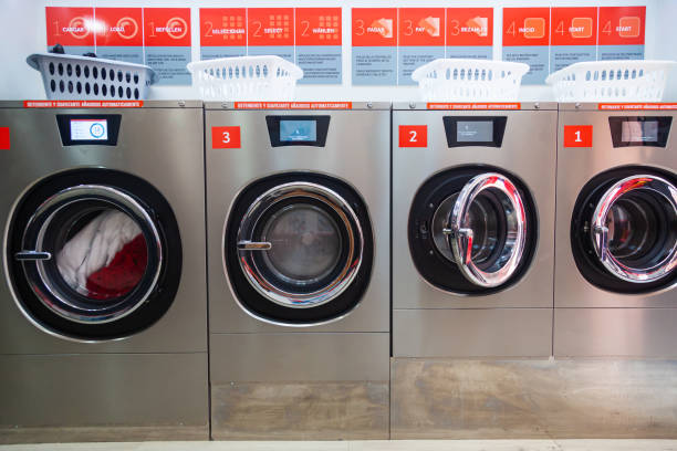 Open door in a washing machine row, strong contrast, white background,