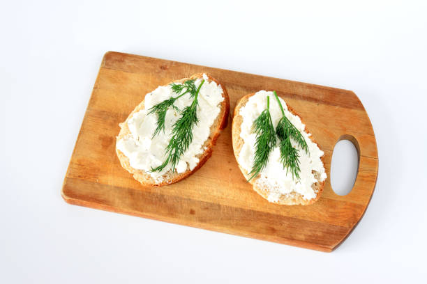 sandwiches with cream cheese and dill isolated on cutting board