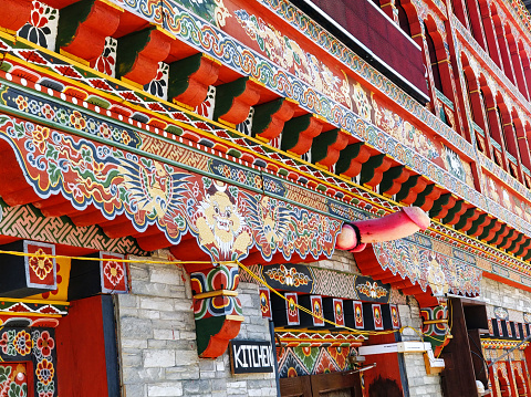 A building in the heart of the city adorned with intricate carvings, ornate sculptures, and detailed reliefs with Phallic fertility symbol, shot at Bhutan.