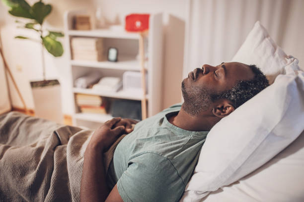 istock Man sleeping in hospital bed 2032933033