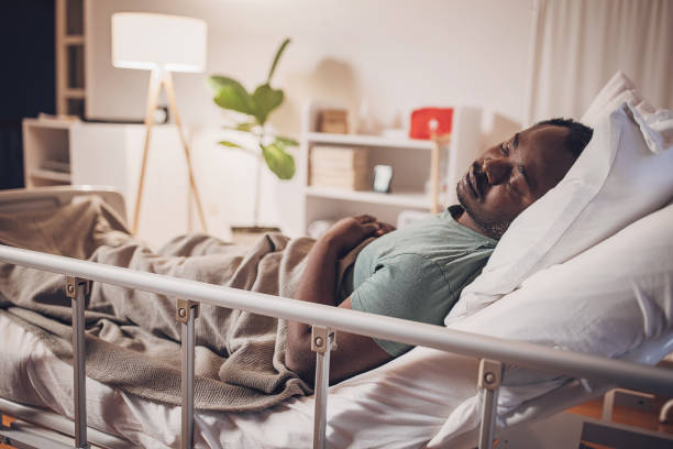 istock Man sleeping in hospital bed 2032934063