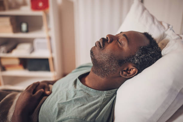 istock Man sleeping in hospital bed 2032934571