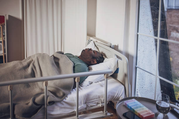 istock Man sleeping in hospital bed 2032939874