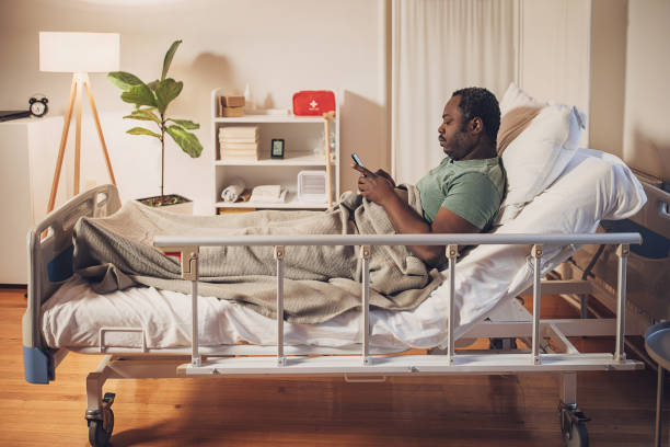 istock Man killing time in hospital bed 2032942846