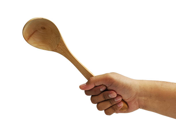 istock Hand holding Wooden soup spoon isolated on white background 2032944910