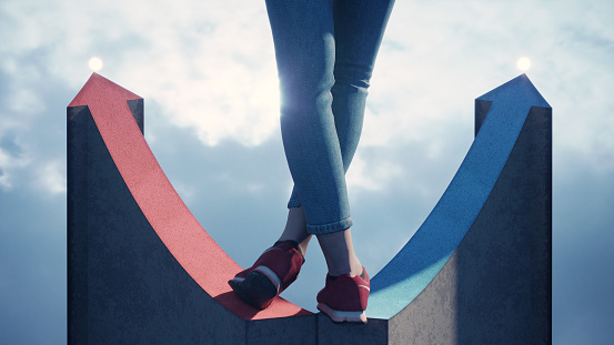 Woman standing on two different colored arrow shaped paths. (3d render)