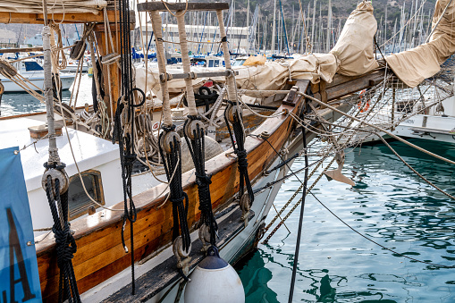 Cartagena, Murcia - Spain - 01-16-2024: Intricate ropes and sails of a classic boat at Cartagena's marina