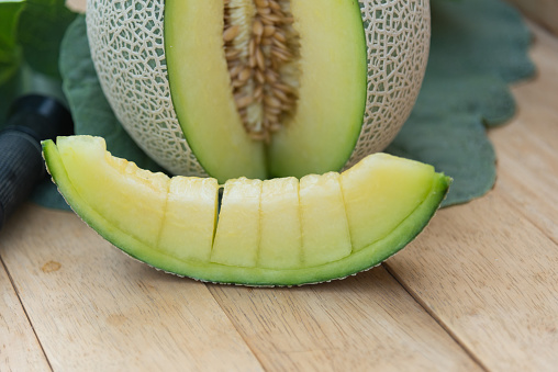 Sweet Fresh green melon on wood plate