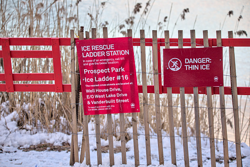 Brooklyn, NY - Feb 17, 2024: Ice Rescue Ladder with Danger Thin Ice sign by Prospect Park Lake in Brooklyn, New York City.