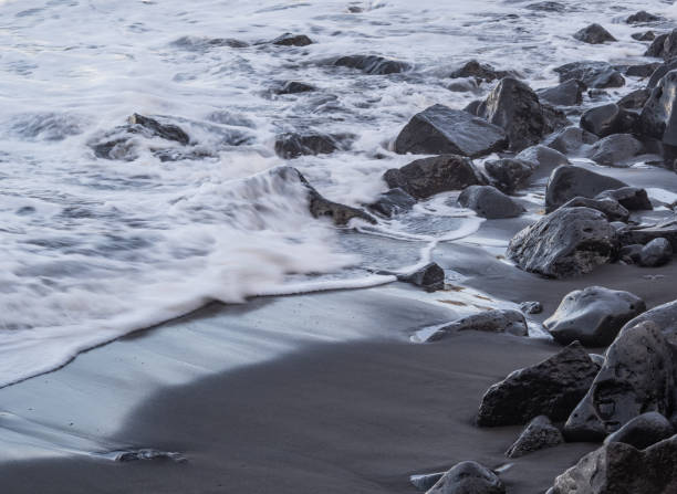 istock beach with black volcanic sand on  Tenerife 2033006675