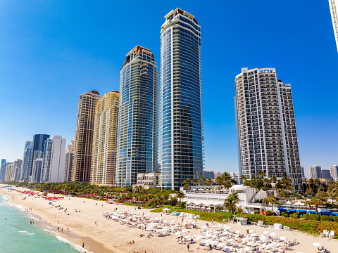 Winter in Miami Florida. View of beachfront condominiums and tourists on the sand