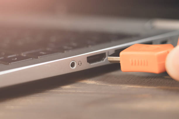 istock Man is insert the cable HDMI into the Port for information transfer. Close up, modern technology. Side panel on a laptop. Different ports for connection. 2033050060