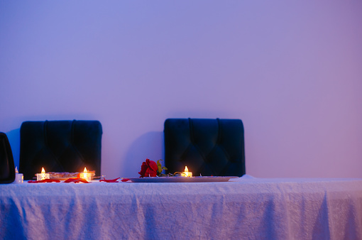 Table with red rose with burning candles stock photo
