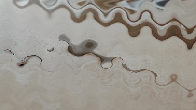 Slow motion watercolor shades of brown water puddle wavy abstract composition.