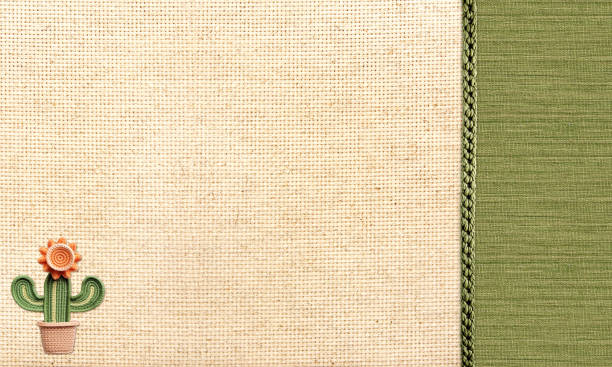 Travel background with beige and green canvas texture and knitted cactus. Ecology, environmental conservation and zero waste concept. Mock up template. Copy space for text stock photo