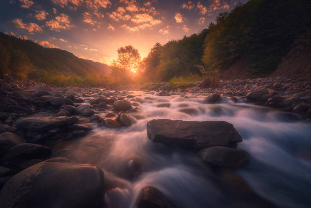 istock Magical sunrise over fast flowing mountain river 2033126997