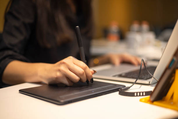 istock Creative working with a special pencil on the laptop 2033134174
