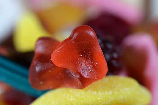 Gummy candy, Gummies, gummi candies, gummy candies, or jelly sweets,  gelatin-based chewable sweets. Gummy sour jelly sweets candies in various shapes, a popular confectionery for children, selective focus