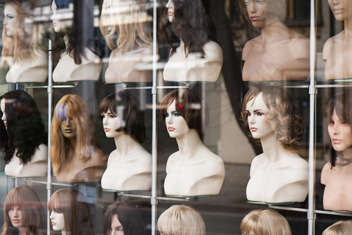 Group of Asian female mannequin heads wearing wigs.