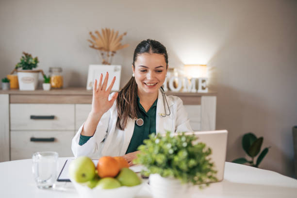 istock Young lady doctor in white medical uniform using computer laptop. 2033146004