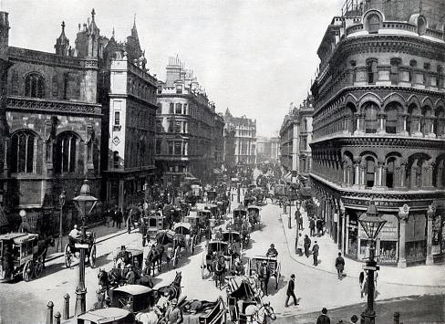 Busy rush hour on street in London England, Queen Victoria Street filled with horse carriages