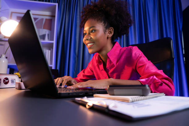 istock African blogger with happy face, looking on laptop with project. Tastemaker. 2033164455