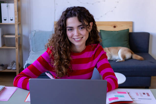 istock Smiling woman working from home with dog 2033182939