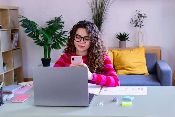 istock Young woman working and texting in home office 2033184203