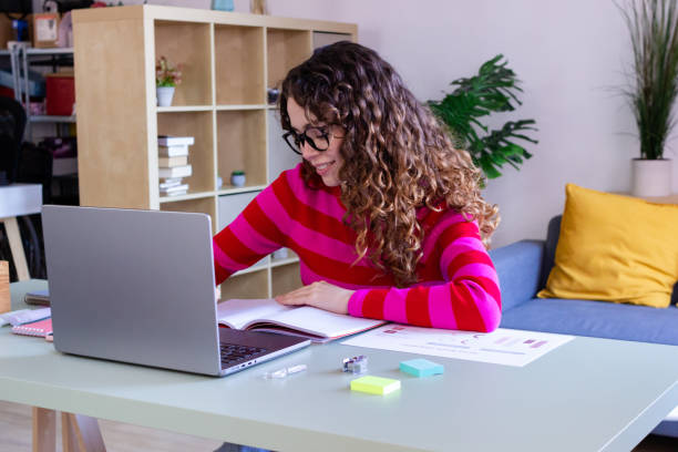 istock Young woman focused on work at home office 2033194679