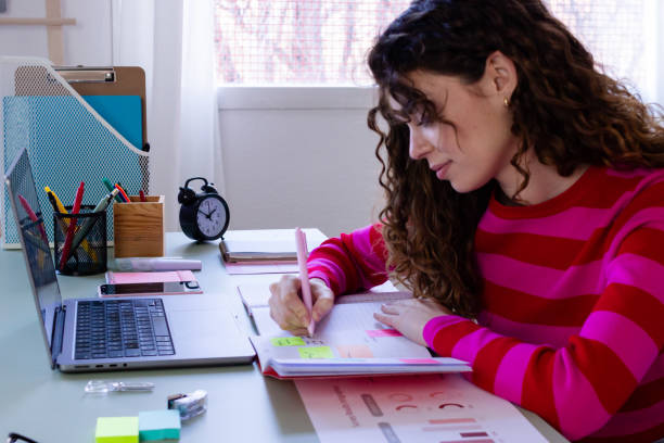 istock Woman focused on planning and writing at her desk 2033196249