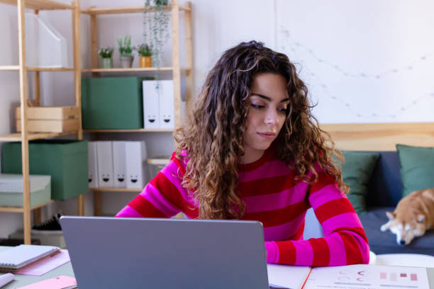 istock Young woman working from home office with pet 2033196782