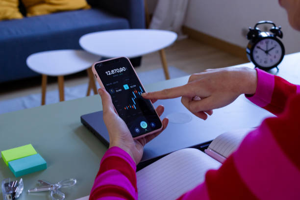 istock Businesswoman analyzing financial app on smartphone 2033197816