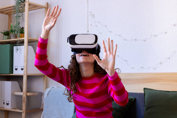 istock Woman enjoying virtual reality experience at home 2033199372