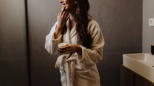 istock Woman applying moisturiser on face 2033202476