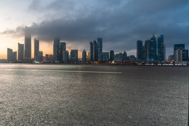 istock empty asphalt road with modern cityscape during sunset. 2033230651