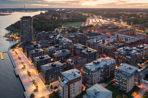 Aerial view of a modern residential area with apartment buildings on a summer evening in Lidingö, Sweden.