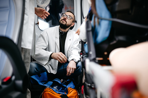 Young doctor doing his job in an ambulance
