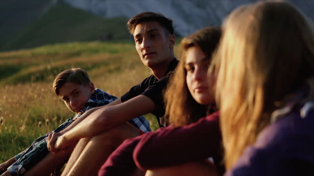 Mountain adventures: teenagers portrait at sunset