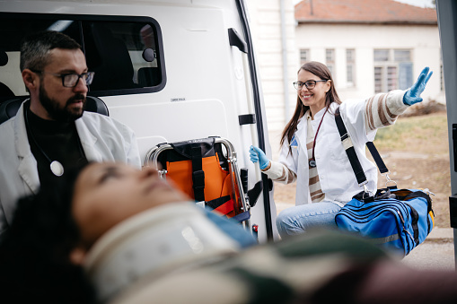 Young paramedic entering an ambulance