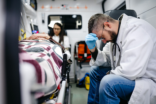 Doctors having a stressful day in an ambulance vehicle