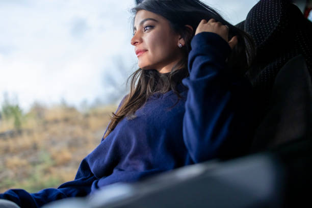 istock Happy young woman travelling by bus 2033283352